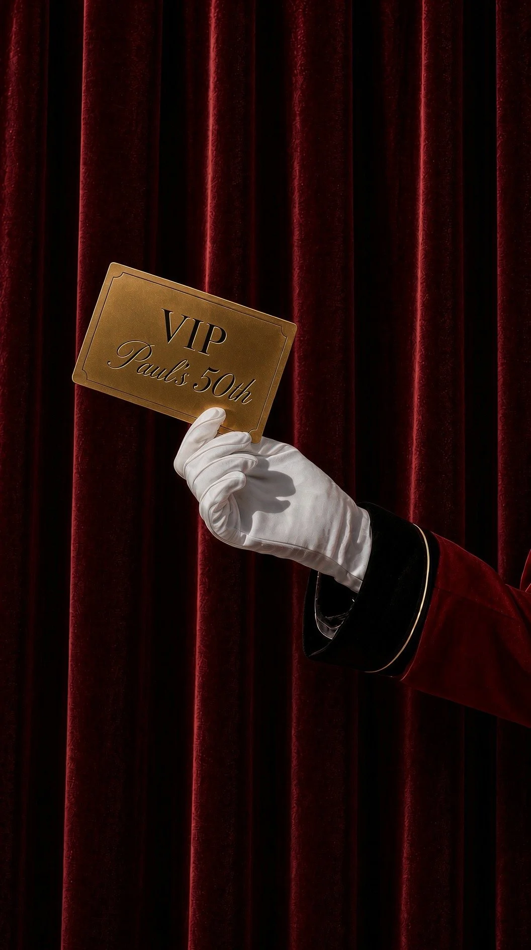A gold VIP card for Paul’s 50th held against a red velvet curtain